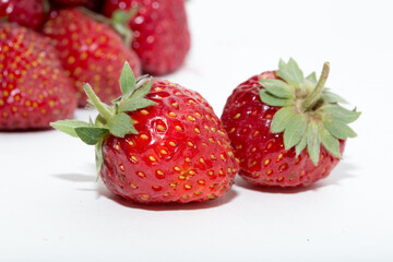 Strawberries on a white background. Strawberry close-up isolated. Juicy berries picked for dessert.