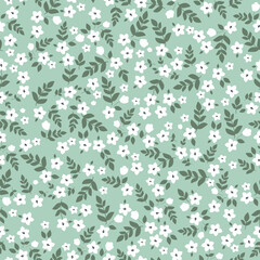 Vintage floral pattern with small white flowers,green leaves on a light green background. Seamless pattern for design and fashion prints.Stock vector illustration.