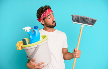 young crazy bearded and expressive man with clean products. housekeeper concept