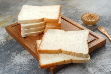 white bread or sliced bread in the basket on wooden board 