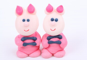 Doll made of colored sugar isolated on white