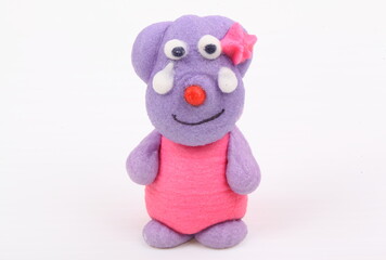 Doll made of colored sugar isolated on white