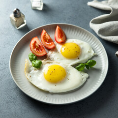 Roasted eggs with tomatoes and basil