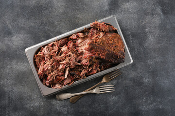 Traditional barbecue pulled pork. Slow cooked pulled pork shoulder. Juicy pork meat cooked in a smoker by low and slow