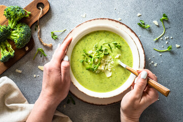 Green soup. Broccoli cream soup with cream and parmesan. Healthy vegan dish. Top view at white...