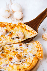 Tasty fresh baked pizza with champignons and chicken fillet