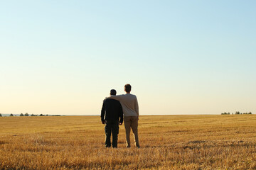 Young adult son and father in the autumn meadow on a blue sky background. Pavel Kubarkov, i and my Father Alexander. Photo was taken 10 September 2022 year, MSK time in Russia. - 532712796