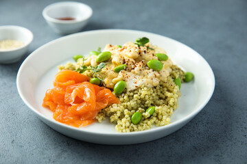 Scrambled eggs with couscous, salmon and beans
