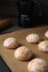 Tasty homemade gingerbread cookies on baking tray, closeup