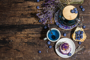 The concept of romantic tea. French Shu cake, Lavender tea, blueberries, festive decor