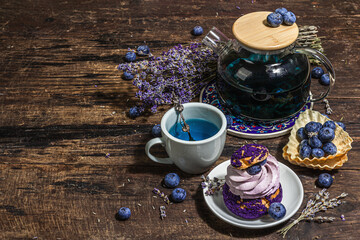 The concept of romantic tea. French Shu cake, Lavender tea, blueberries, festive decor