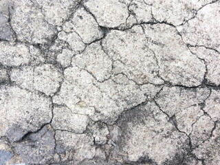 Cracked concrete texture closeup background.