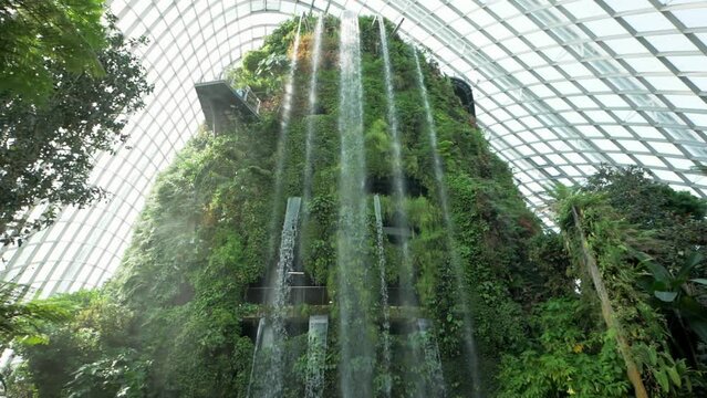 Waterfall inside of the Cloud Forest Dome at Gardens by the Bay in Singapore. Slowmotion