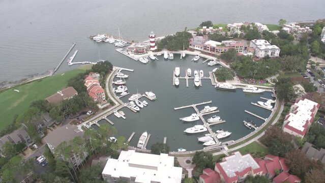 High wide aerial pulling away from Hilton Head Marina in summertime