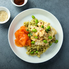Scrambled eggs with couscous, salmon and beans