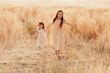 Little girl wear casual dress walking in country rural field.