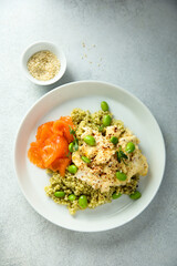 Scrambled eggs with couscous, salmon and beans