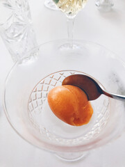 Sea buckthorn sorbet served in a glass dessert cup.