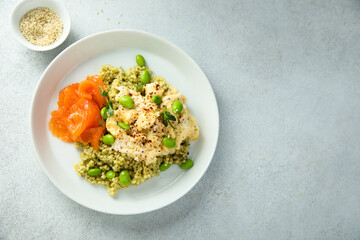 Scrambled eggs with couscous, salmon and beans