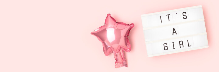 Its a girl - quote. Banner with pink star foil balloon and lightbox. Place for text.