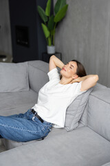 Young pretty woman relaxing on couch in living room