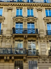 Fototapeta na wymiar Paris, September 2022 : Visit of the magnificent city of Paris, Capital of France - View on different facades of buildings built by Baron Haussmann 