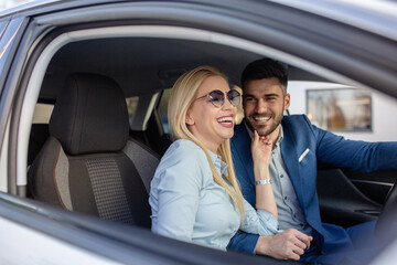 Shot of a cheerful beautiful couple driving in a car together and enjoying in the road trip.