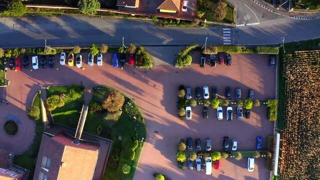 Cars parked in parking area of Santo Stefano luxurious hotel at Sandigliano village, Piedmont in Italy. Aerial top down directly above 