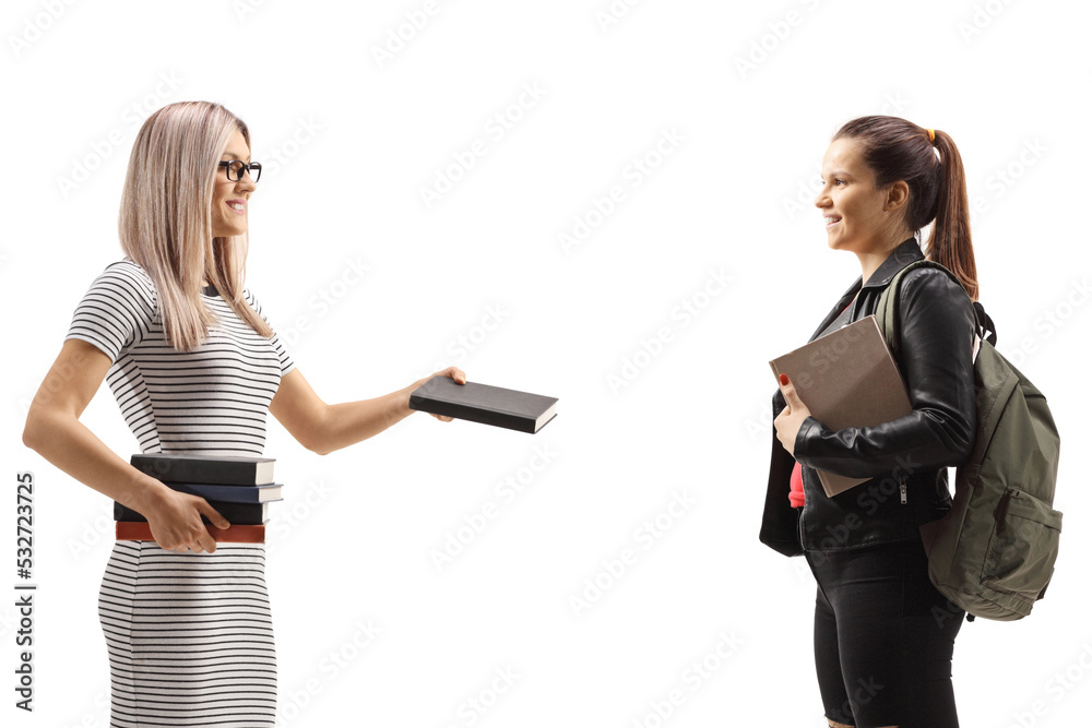 Wall mural profile shot of a young woman giving a book to a female student