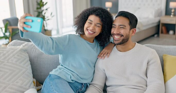 Happy couple, phone selfie and smile on living room sofa for love, relax and fun together. Young man, woman and people in relationship on lounge couch taking mobile photos for social media online