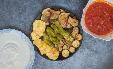 Traditional delicious Turkish food, fried mixed vegetables (potatoes, eggplant, zucchini, roasted peppers), Turkish name; mixed fried vegetables