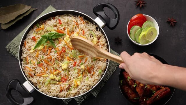 Chinese fried rice and chilly chicken curry. 4k video of  Chicken fried rice with vegetables fried eggs basmati grain very popular food in restaurants Kerala Mumbai India Sri Lanka china