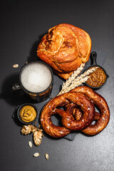 Traditional Oktoberfest set. Pretzels, beer, smoked pork knuckle eisbein with mustard