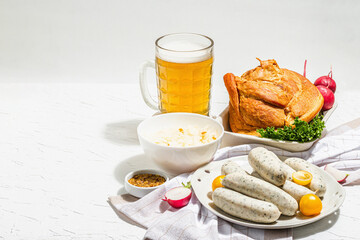 Traditional Oktoberfest set. Beer, weisswurst, smoked pork knuckle eisbein with fermented cabbage