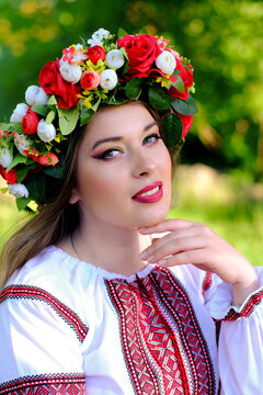 Close-up portrait of a beautiful Ukrainian girl in a traditional dress and a wreath on her head. Vertical image.