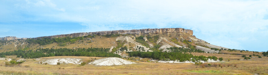 Fototapeta na wymiar Panorama of the white rock on the plain under the blue sky