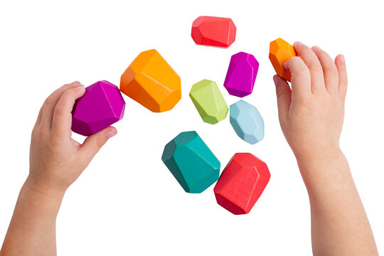 Wooden colorful  toy blocks isolated in kid hands , rainbow color. Baby development. Design element pastel