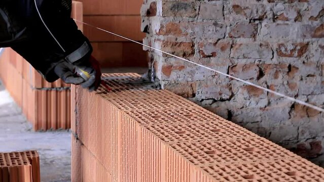 builders building brick wall with red bricks stock footage