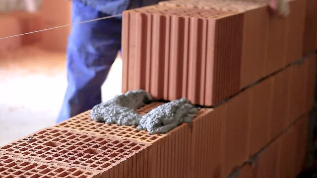 builders building brick wall with red bricks stock footage
