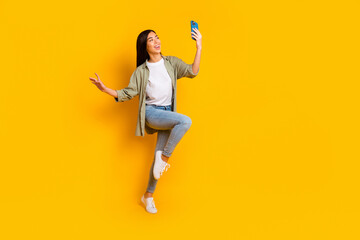 Fototapeta na wymiar Full size portrait of excited crazy lady hold telephone make selfie have good mood isolated on yellow color background