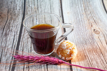 Cup of coffee on woody background.
