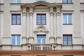 Balconies with columns on facade of old residential building. Stalinist architecture, building on...