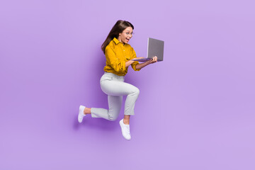 Full body profile portrait of energetic excited lady run jump use wireless netbook isolated on purple color background