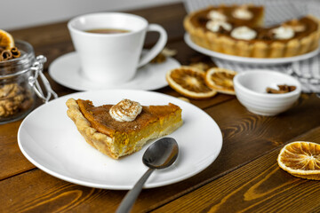 Delicious pumpkin pie, thanksgiving day pie on wooden background