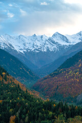 Fototapeta na wymiar Beautiful mountain autumn landscape with colorful trees, impressive snow peaks. Picturesque landscapes of Svaneti, Georgia. Vertical photo