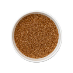 top view of unrefined natural brown sugar in ceramic bowl isolated on white background, cane sugar close-up