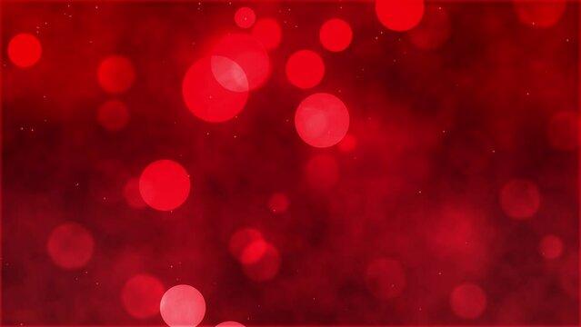 Red abstract background with round blurred particles. Bright glow falling across the screen. red blurred background