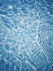 Bluewater waves on the surface ripples blurred. Defocus blurred transparent blue colored clear calm water surface texture with splash and bubbles. Water waves with shining pattern texture background.