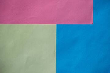 Geometric spring color block background in soft pastel trend colors, made from watercolor paper. Abstract geometric background with 3 multicolored sectors.