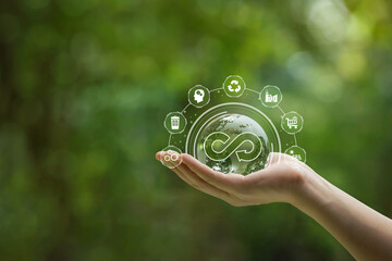 Circular economy concept. Hand-holding crystal globe with a circular economy icon around it. Ideas for future growth of business and design to reuse and renewable material resources.reuse .renewable - obrazy, fototapety, plakaty